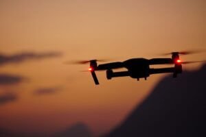 black and red drone flying during daytime